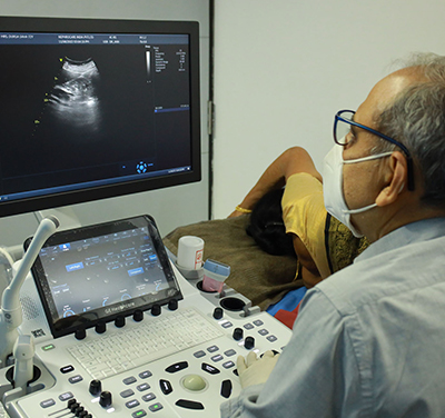 Radiologist doing Ultrasound of a patient.