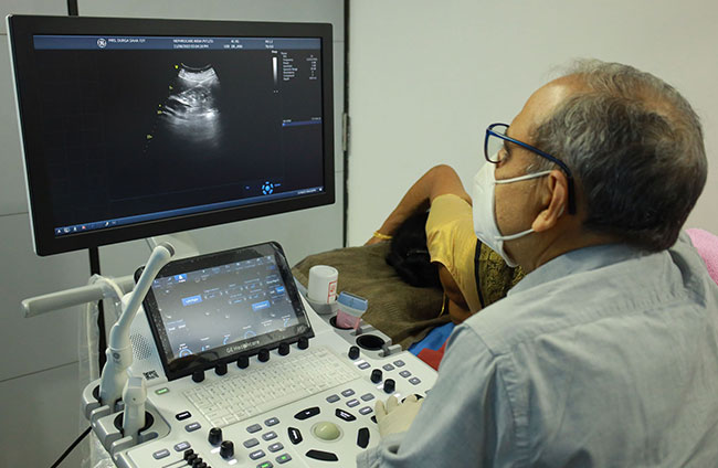 Radiologist doing Ultrasound of a patient.