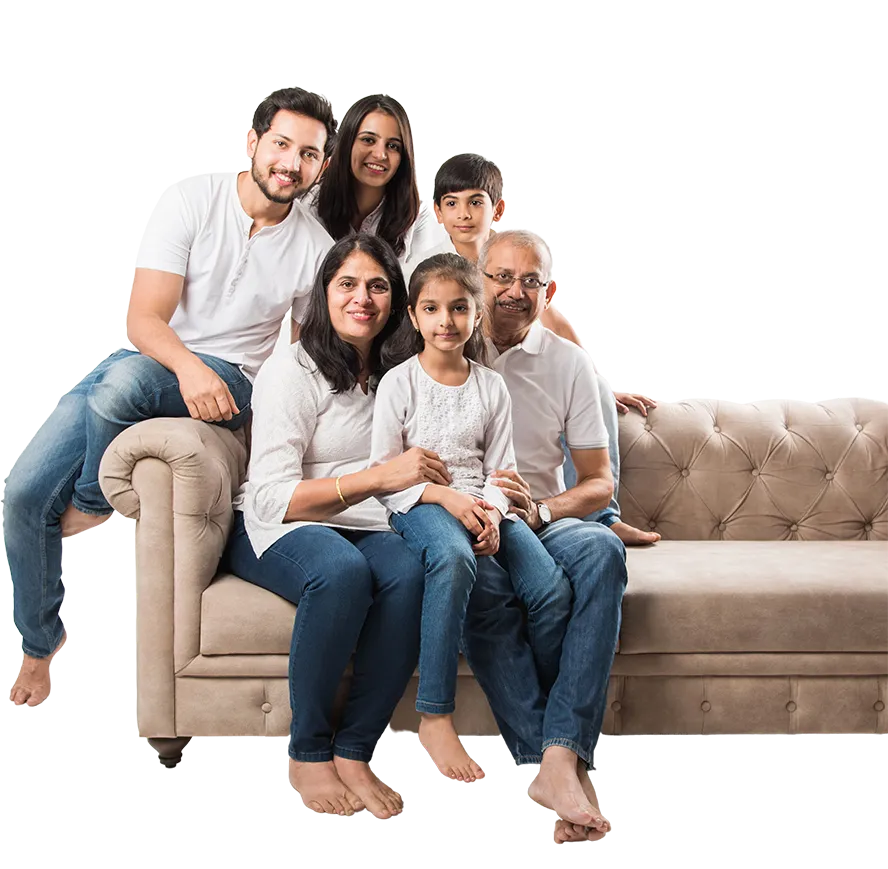 A happy family posing on a couch.
