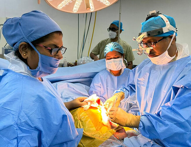 Surgeons operating on a patient in an operating room.