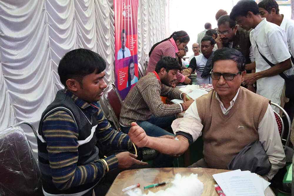 A elderly man getting his blood extracted