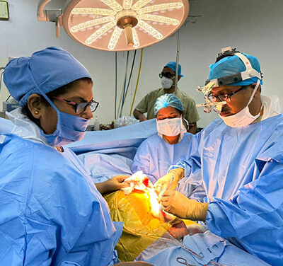 Surgeons operating on a patient in an operating room.