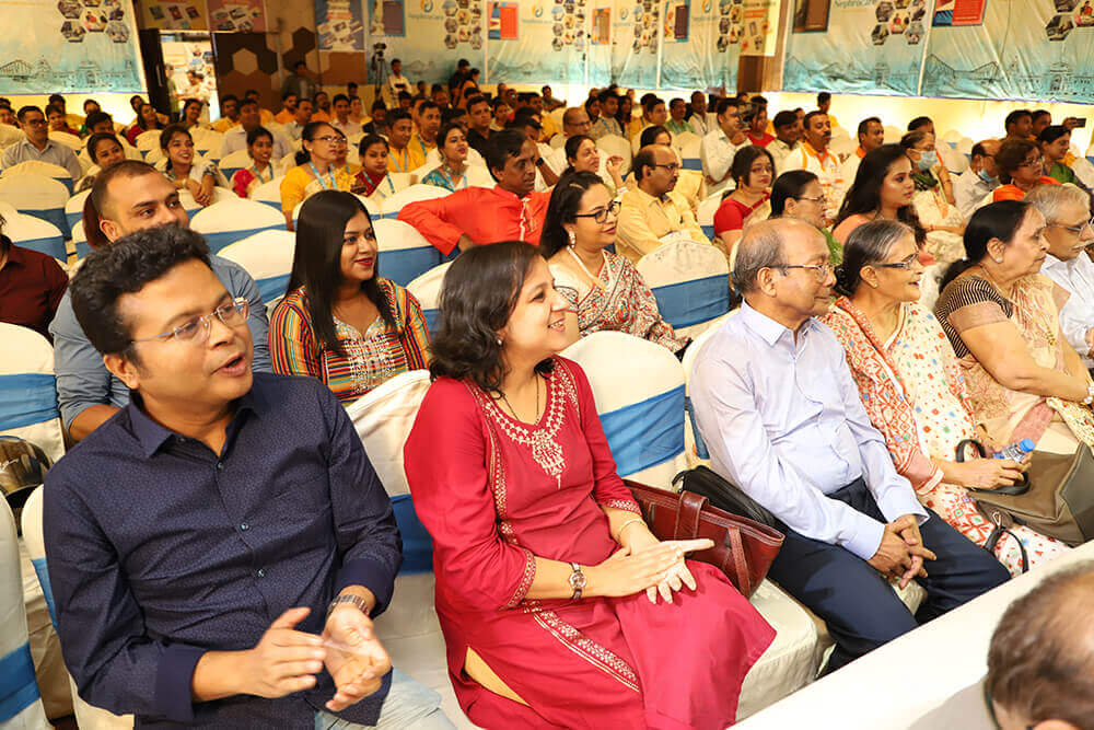 A large group of people sitting in a room.