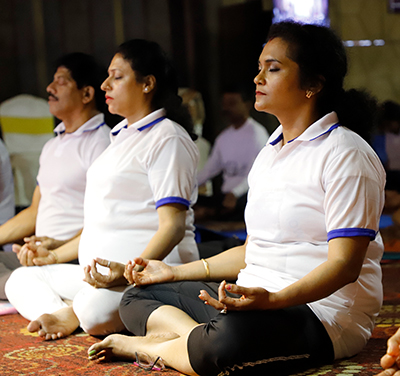 A group of people meditating.